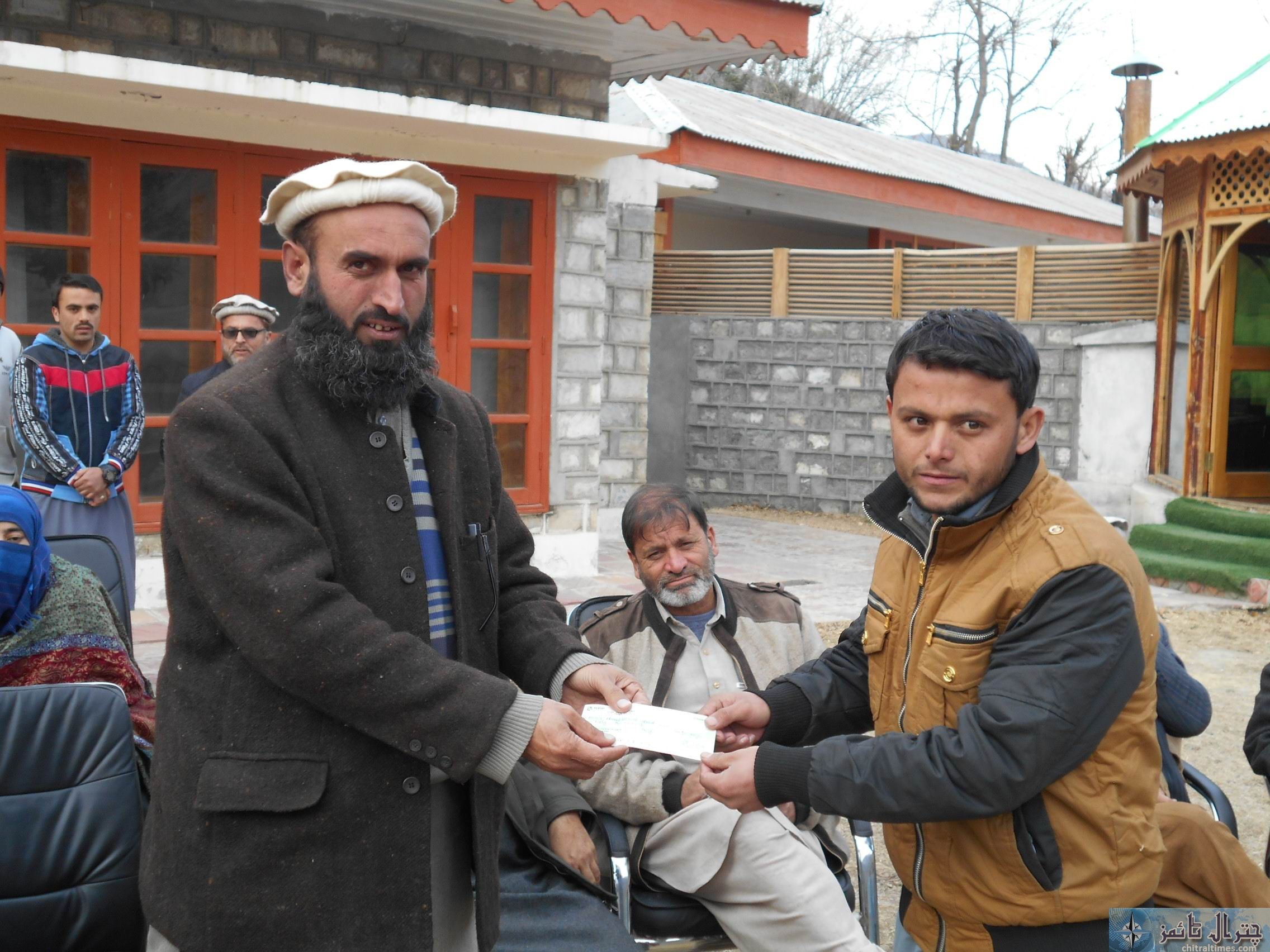 district nazim chitral distributes cheques among students shokor