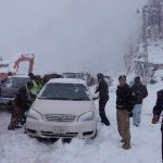 chitral police trying to cross the passenger stuck vehicles near Lowari tunnel due to heavy snow fall here on Monday pic Saif ur Rehman Aziz