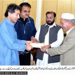 Minister Education giving away a cheque