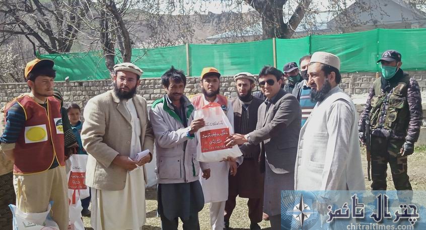 dc upper chitral shah saood distributes relief goods
