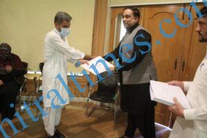 chitraltimes dc chitral hasan abid giving away certificate and prize to polio workers dho