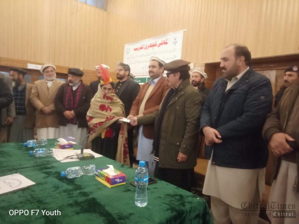 chitraltimes wazir zada giving away cheque to religious leader chitral