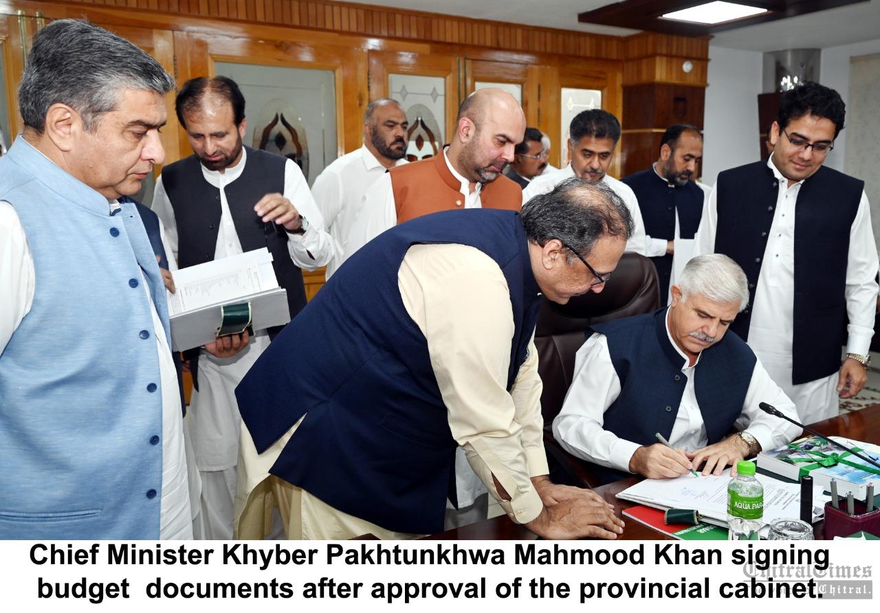 chitraltimes cm kp mahmood signing budget after approval from cabinet