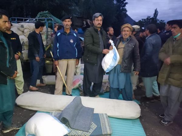 chitraltimes aac mastuj distributing relief to flood affectees of yarkhun valley