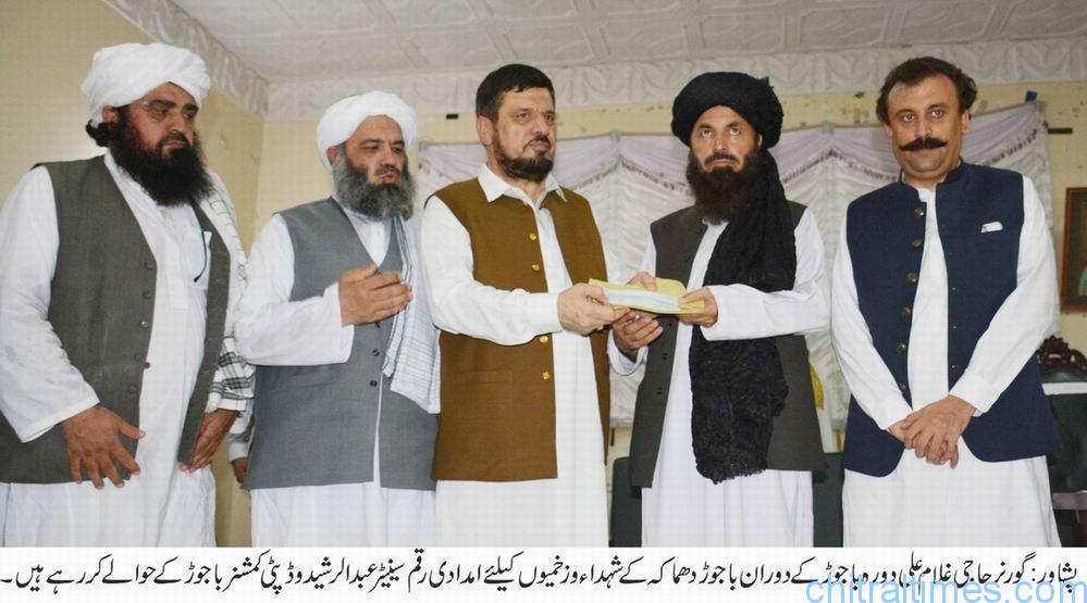 chitraltimes governor kp giving away cheques to bajur bom blast victimes
