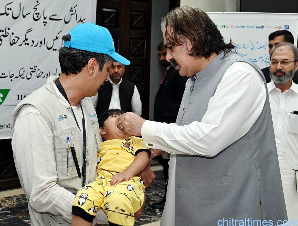 chitraltimes cm kp ali amin gandapur adminstering anti polio drop to a child