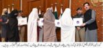 chitraltimes governor kp giving away plot allotment letters to shuhada vorsa